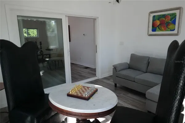 a living room with furniture and wooden floor