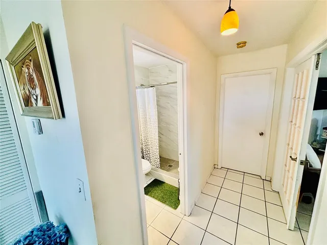 a bathroom with a mirror and a shower