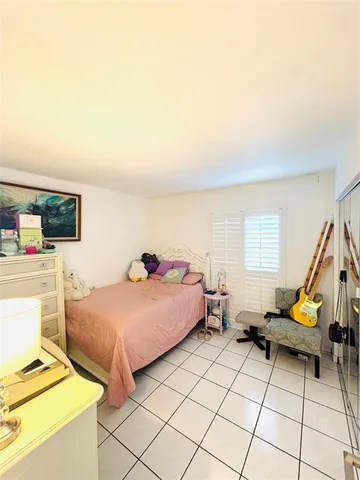 a bedroom with a bed and a tv