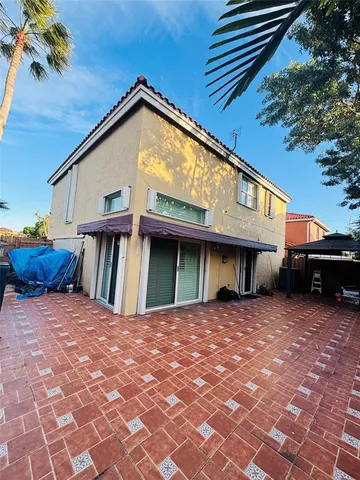 a view of a house with backyard and a patio