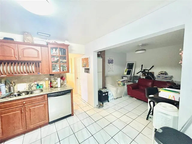 a kitchen with a sink cabinets and window