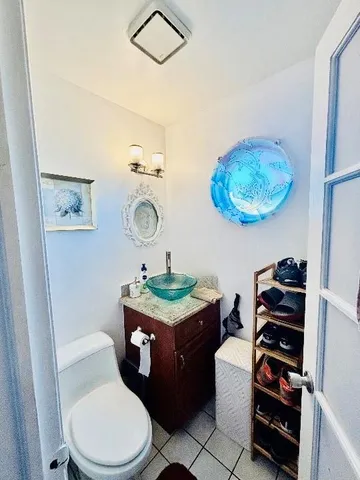 a bathroom with a toilet a sink and a mirror