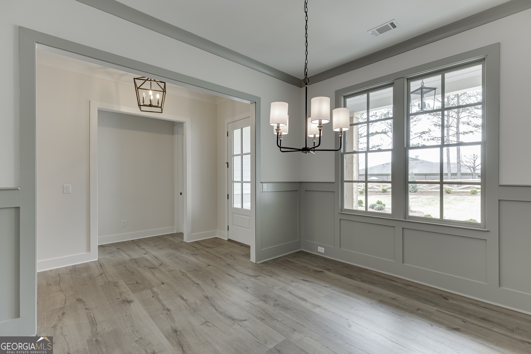 5410 Settingdown Road Cumming, GA 30028 - Photo 12 of 86 a view of empty room with wooden floor and fan