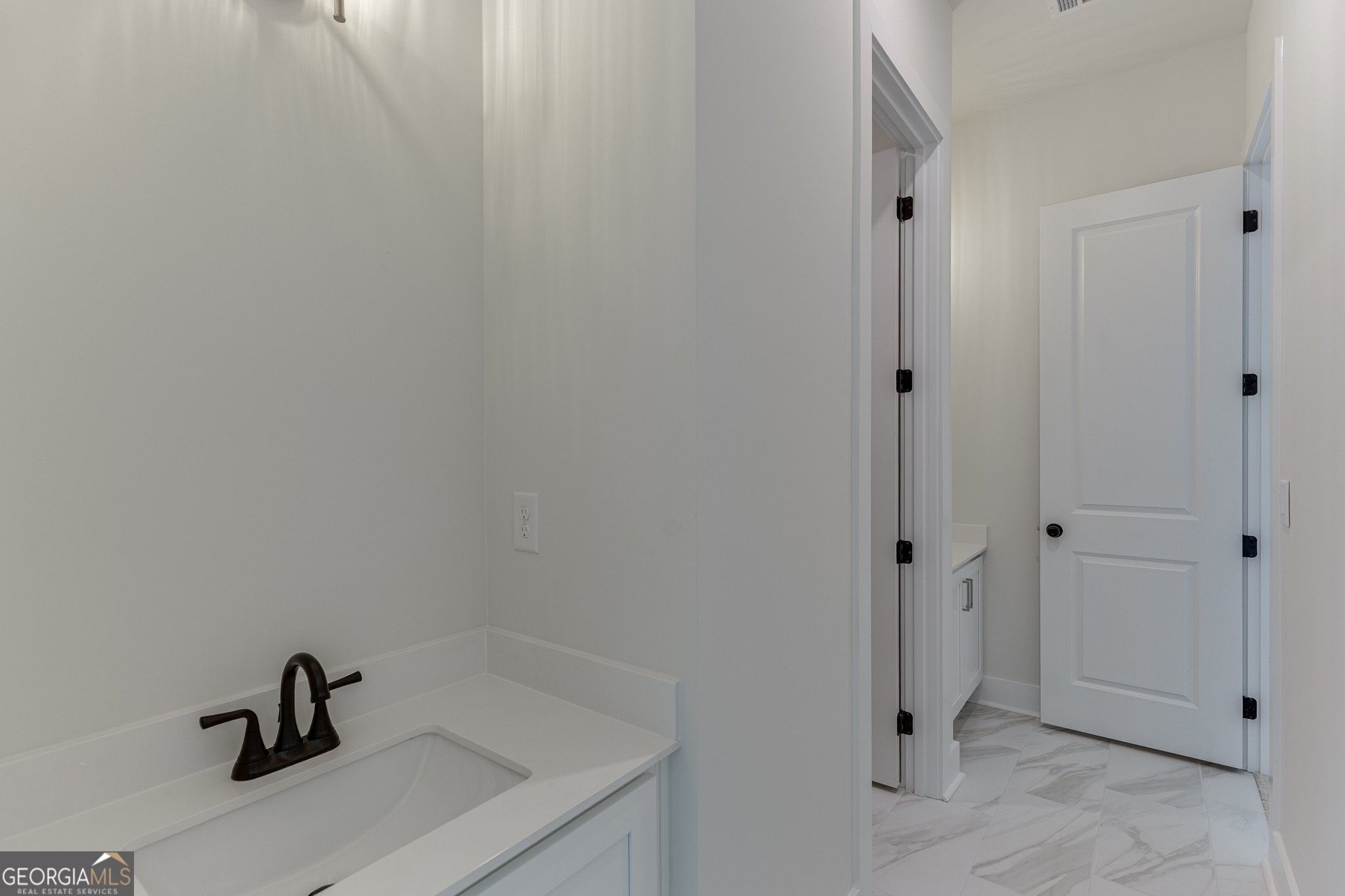 5410 Settingdown Road Cumming, GA 30028 - Photo 26 of 86 a bathroom with a sink and a mirror