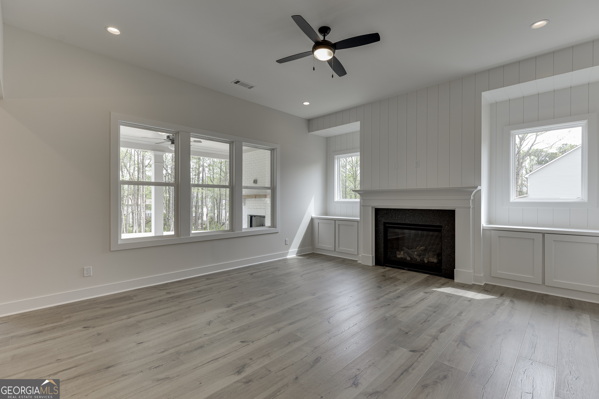 5410 Settingdown Road Cumming, GA 30028 - Photo 28 of 86 a view of empty room with wooden floor and fireplace