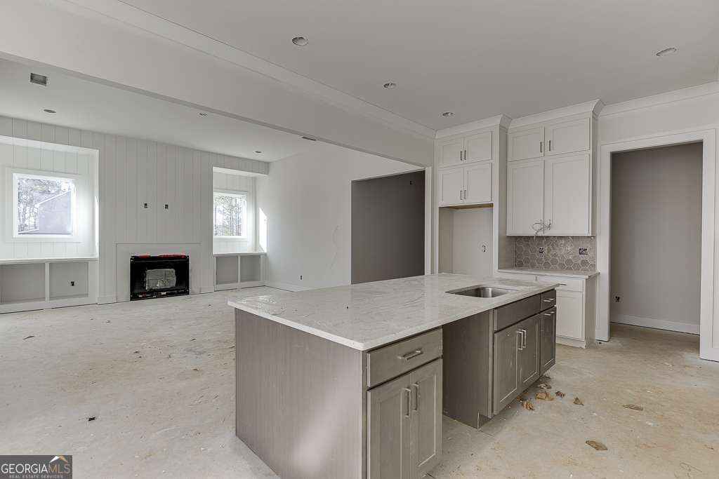 5410 Settingdown Road Cumming, GA 30028 - Photo 41 of 86 a kitchen with a sink and a fireplace