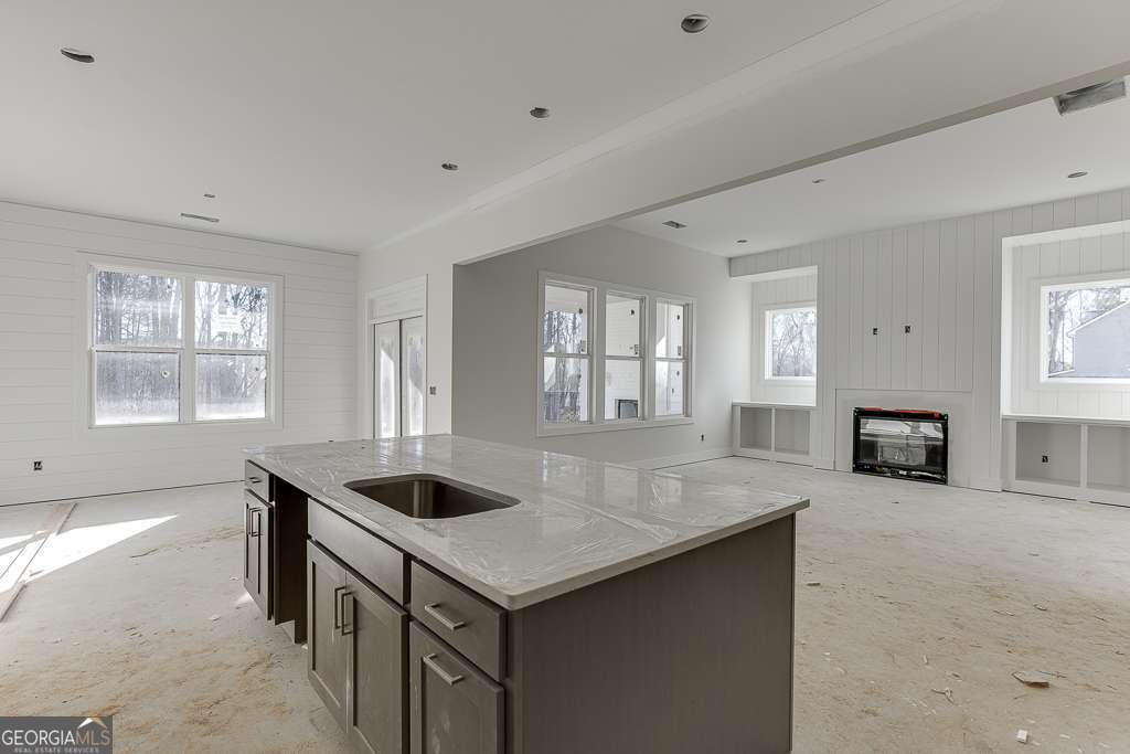 5410 Settingdown Road Cumming, GA 30028 - Photo 43 of 86 a kitchen with granite countertop a sink and white cabinets