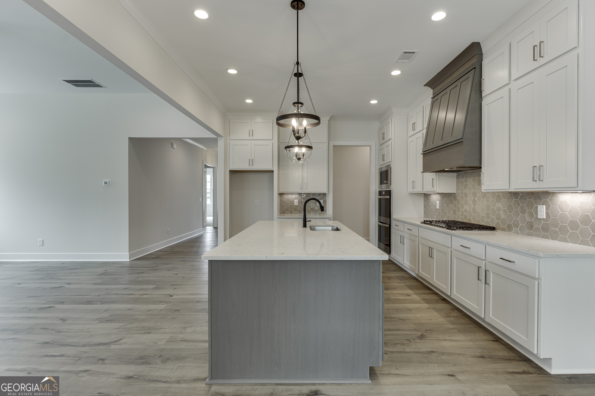 5410 Settingdown Road Cumming, GA 30028 - Photo 46 of 86 a large kitchen with stainless steel appliances granite countertop a sink dishwasher a refrigerator and a stove