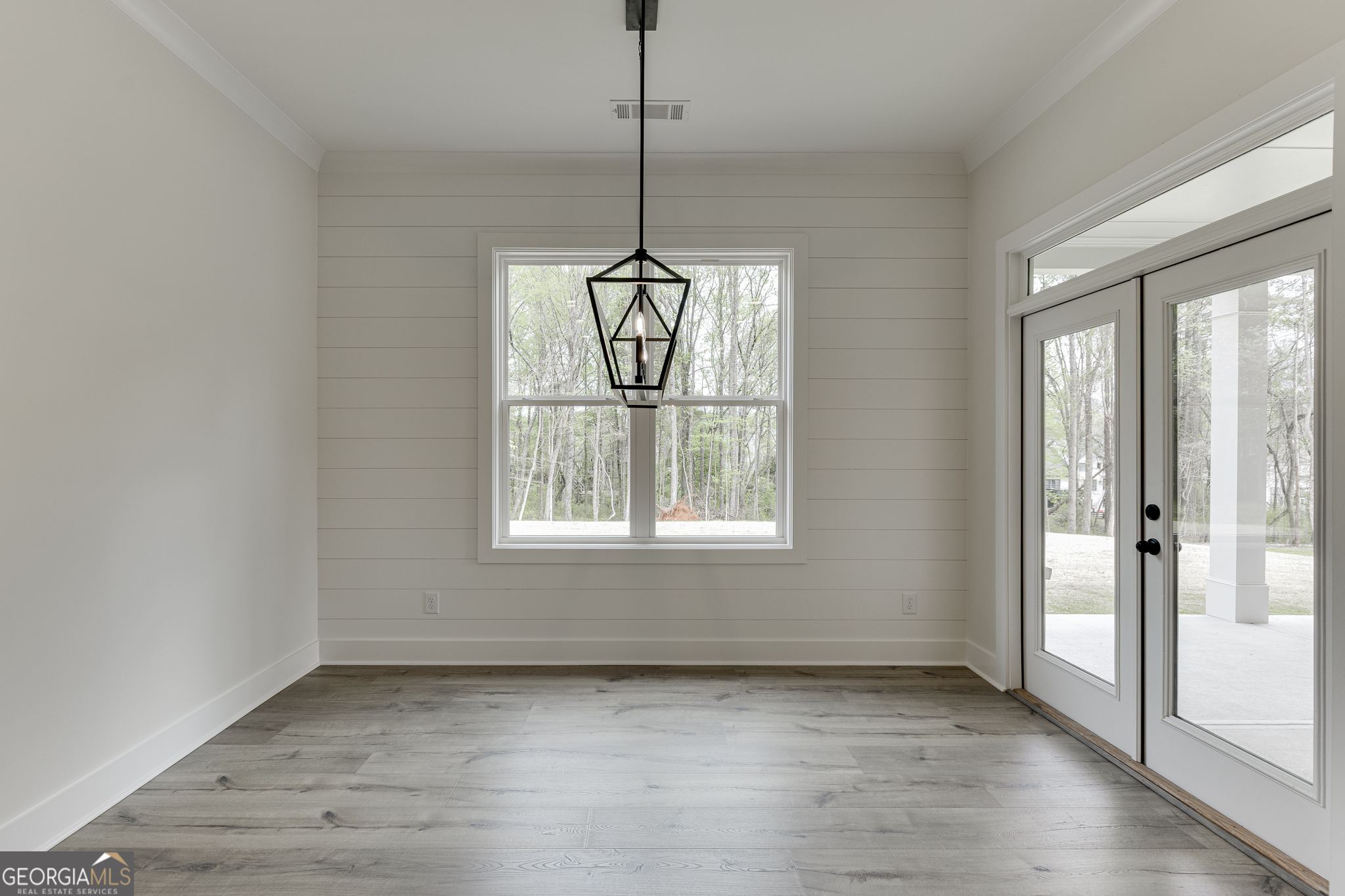 5410 Settingdown Road Cumming, GA 30028 - Photo 48 of 86 a view of an empty room with wooden floor and a window