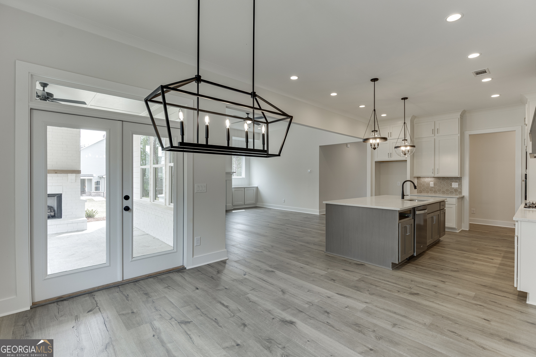 5410 Settingdown Road Cumming, GA 30028 - Photo 52 of 86 a kitchen with stainless steel appliances kitchen island wooden floors granite top and stove