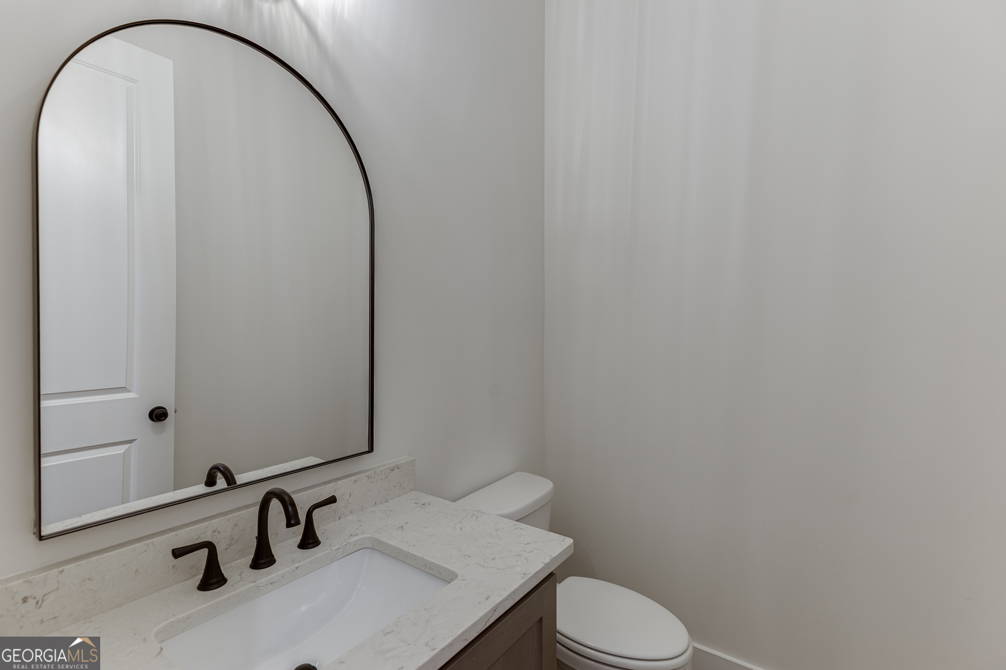 5410 Settingdown Road Cumming, GA 30028 - Photo 54 of 86 a bathroom with a sink a toilet and a mirror