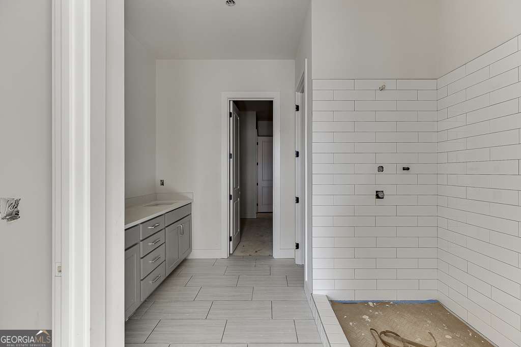 5410 Settingdown Road Cumming, GA 30028 - Photo 55 of 86 a bathroom with a granite countertop sink and a mirror