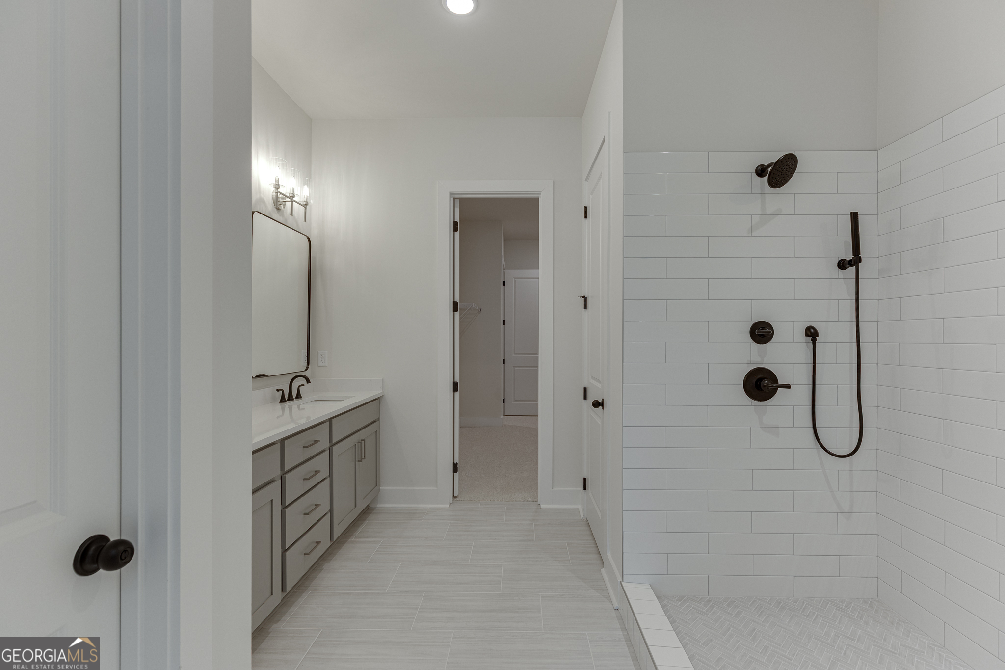 5410 Settingdown Road Cumming, GA 30028 - Photo 64 of 86 a bathroom with a double vanity sink a shower and mirror