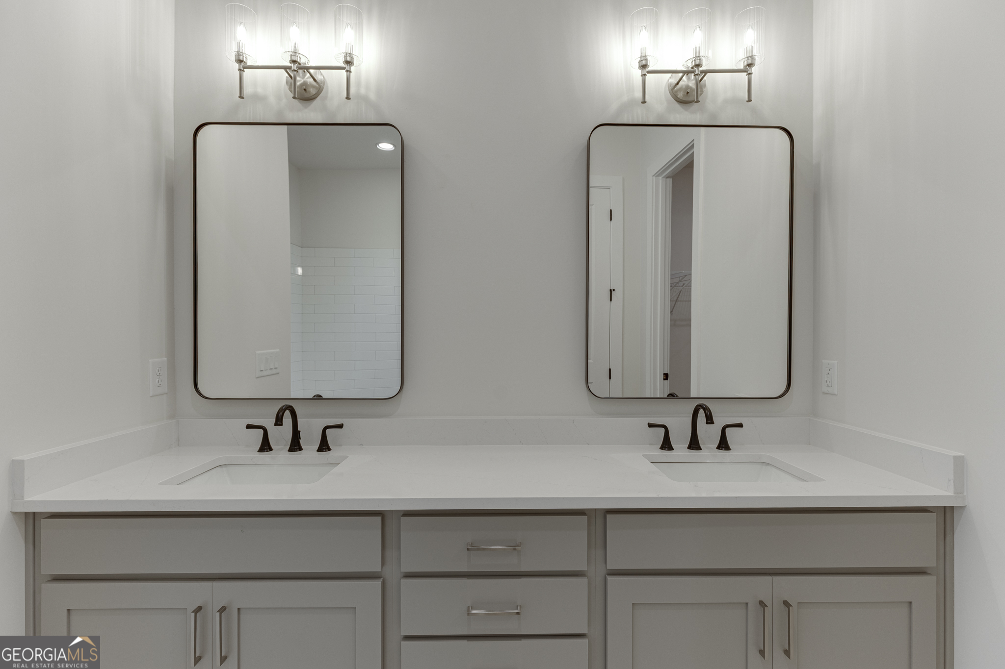 5410 Settingdown Road Cumming, GA 30028 - Photo 66 of 86 a bathroom with double vanity sinks and a mirror