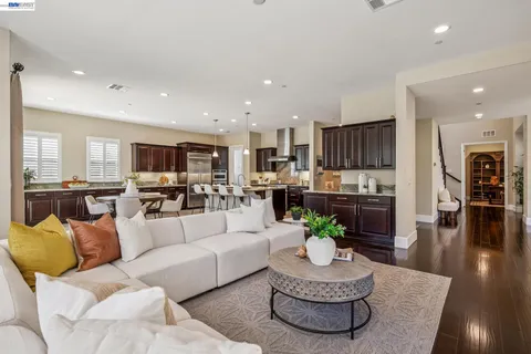 a living room with furniture kitchen and a dining table