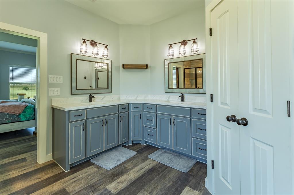 14910 Old Stoney Road Ponder, TX 76259 - Photo 19 of 36 a spacious bathroom with double vanity sink a mirror a window and vanity