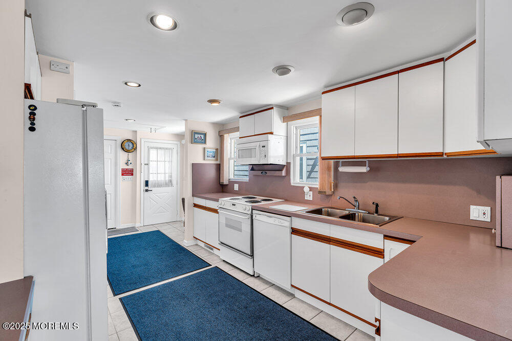 115 Beach Front Manasquan, NJ 08736 - Photo 13 of 32 a kitchen with a sink cabinets and stainless steel appliances