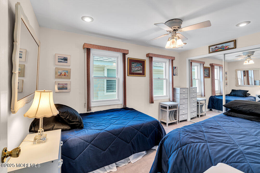 115 Beach Front Manasquan, NJ 08736 - Photo 25 of 32 a bedroom with two beds and a chandelier