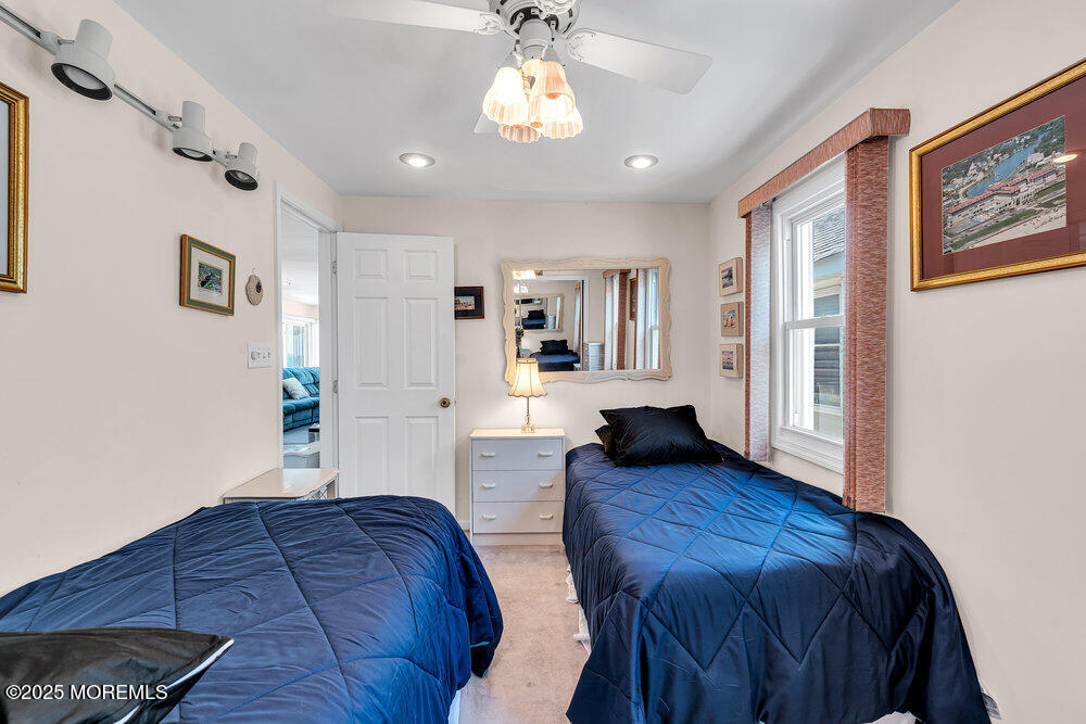 115 Beach Front Manasquan, NJ 08736 - Photo 26 of 32 a spacious bedroom with a large bed and a wooden floor
