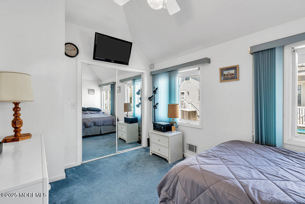 115 Beach Front Manasquan, NJ 08736 - Photo 28 of 32 a bedroom with a bed and a flat screen tv
