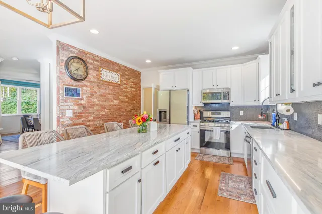 a kitchen with center island and windows