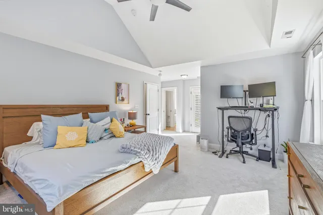 a bedroom with furniture and a flat screen tv