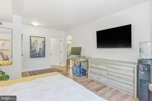 a bedroom with a bed and a couch