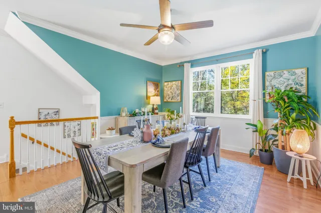 a view of a livingroom with wooden floor and furniture