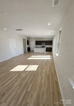 a view of a living room a wooden floor and a fireplace