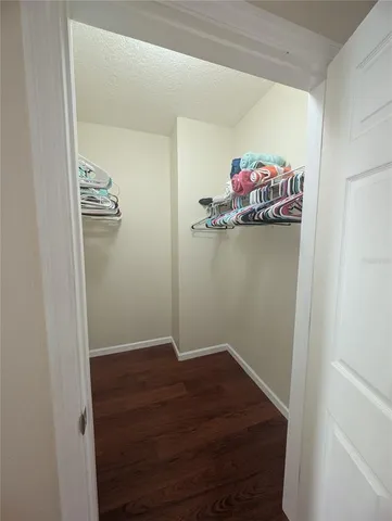 a bedroom with a bed and a tv on the dresser