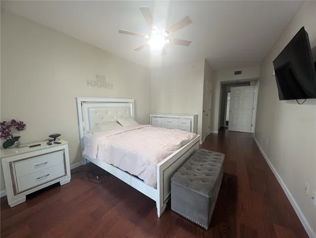 a bedroom with a bed and wooden floor