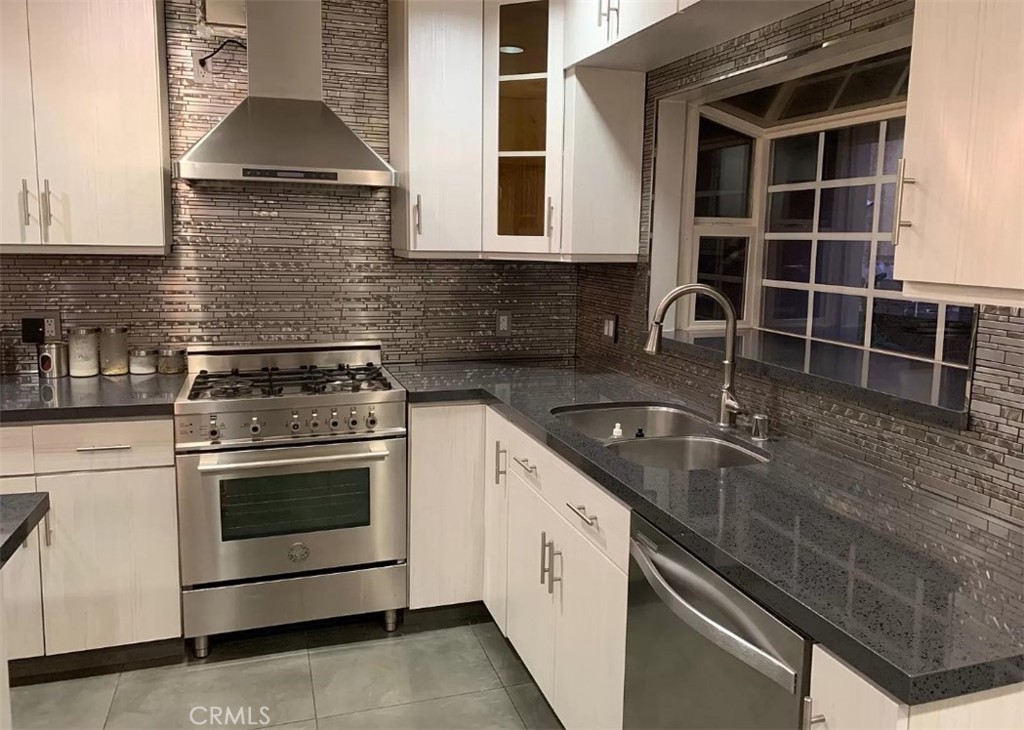 1338 North Jackson Street Glendale, CA 91207 - Photo 13 of 24 a kitchen with granite countertop a stove sink and cabinets