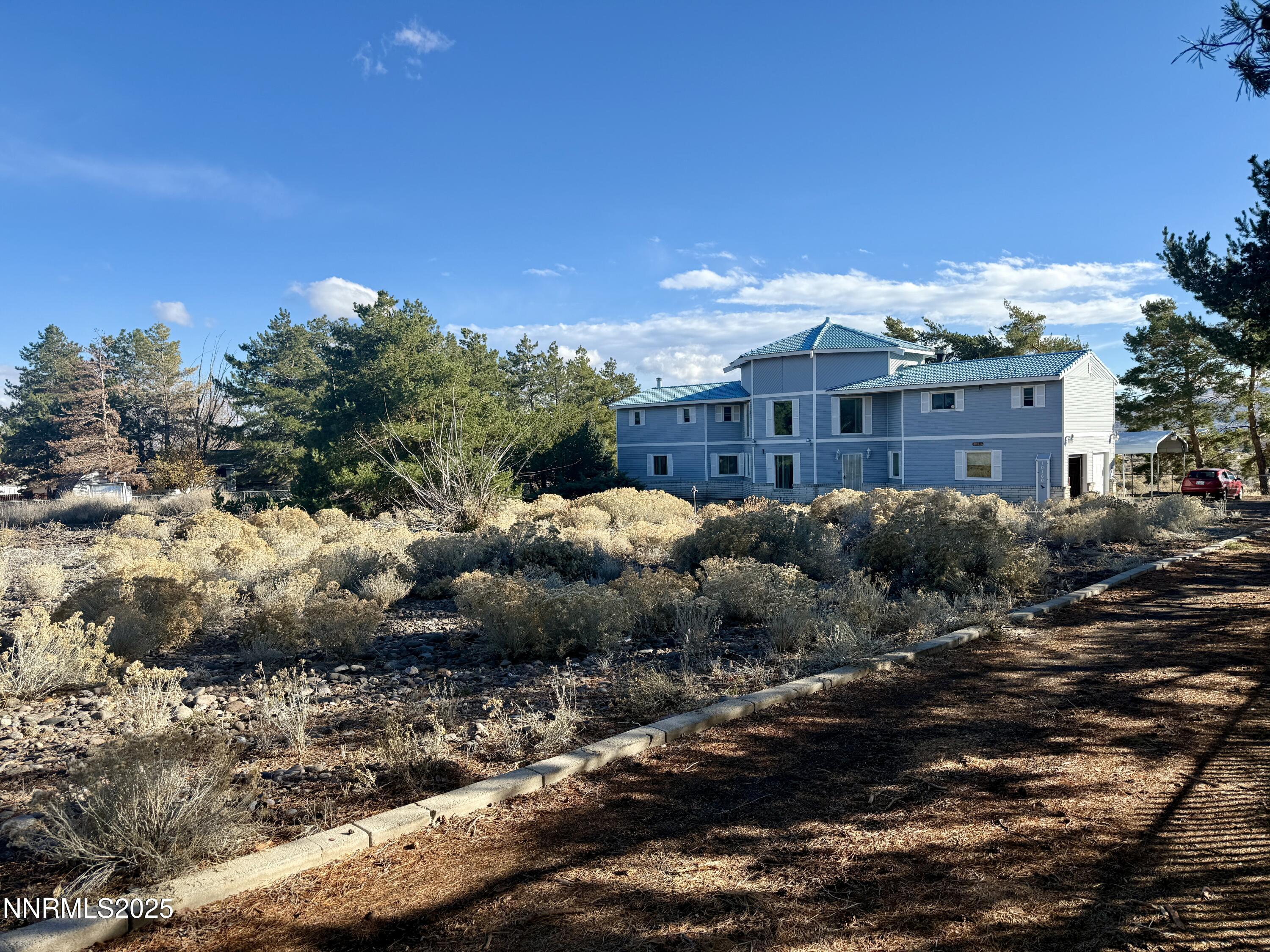 10160 Blackhawk Drive Reno, NV 89508 - Photo 3 of 43 a view of a large building with a yard