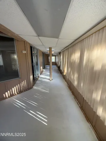 a view of a hallway with entryway and stairs