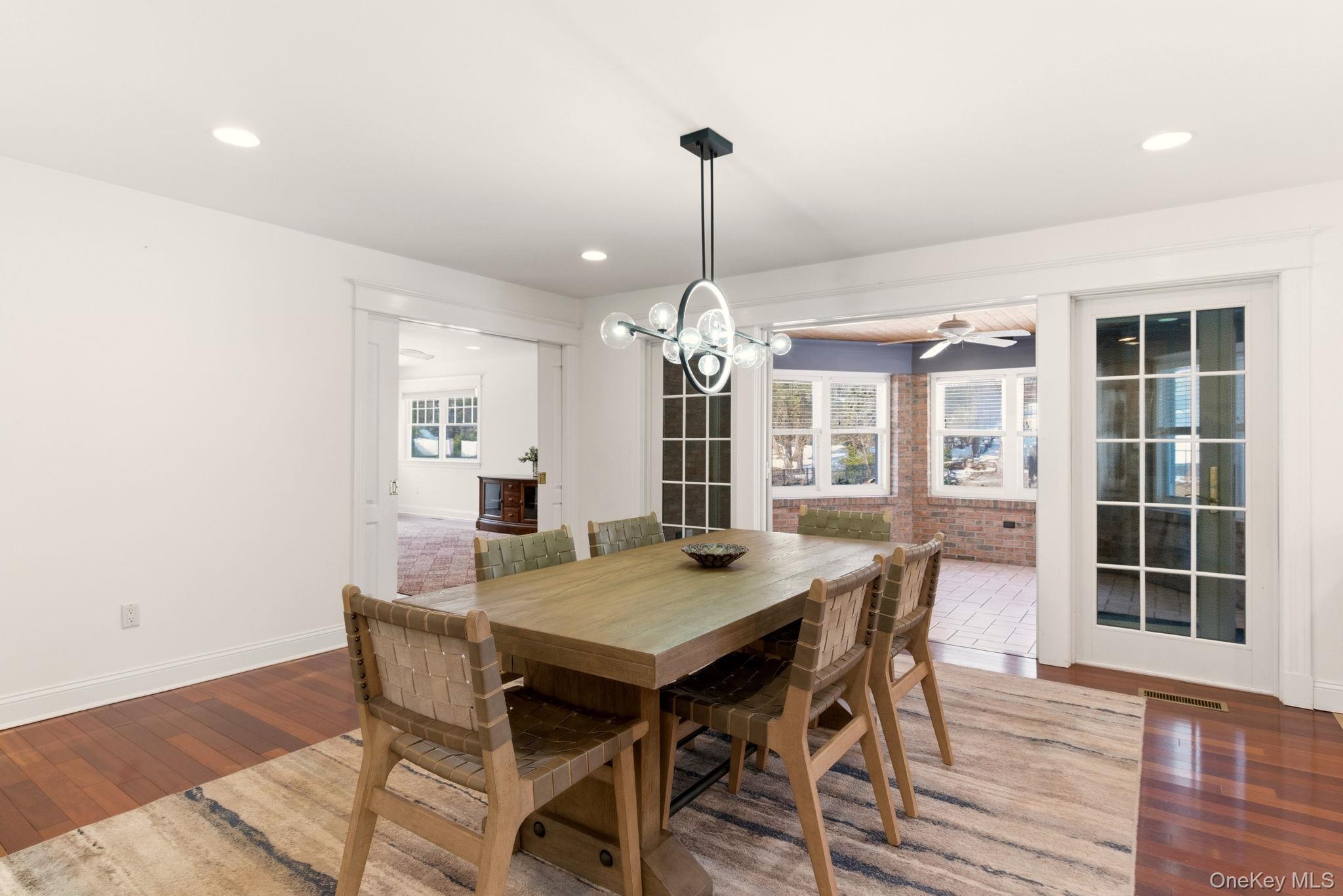 9 Mariners Court Centerport, NY 11721 - Photo 11 of 40 a view of a dining room with furniture window and wooden floor