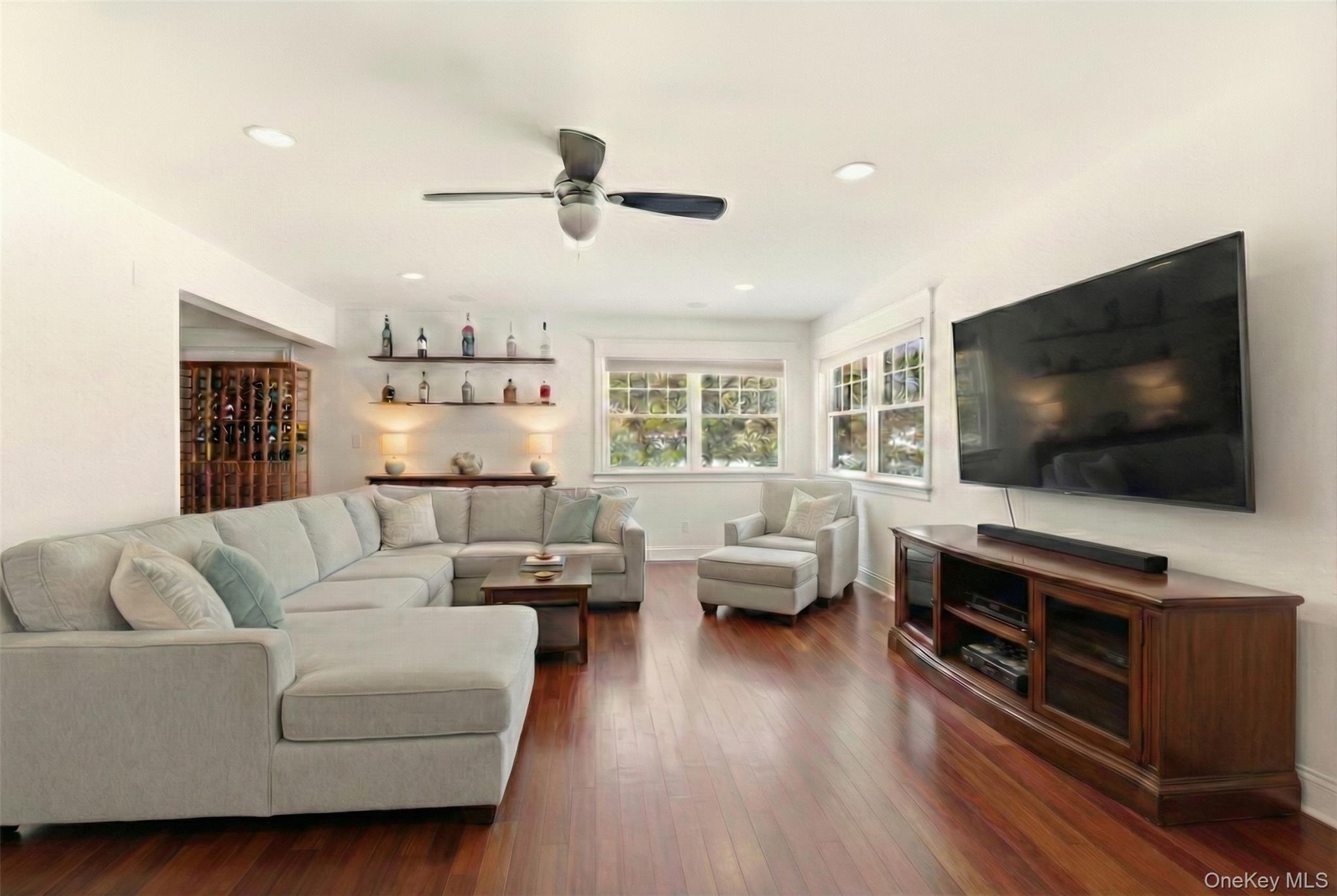 9 Mariners Court Centerport, NY 11721 - Photo 12 of 40 a living room with furniture and a flat screen tv