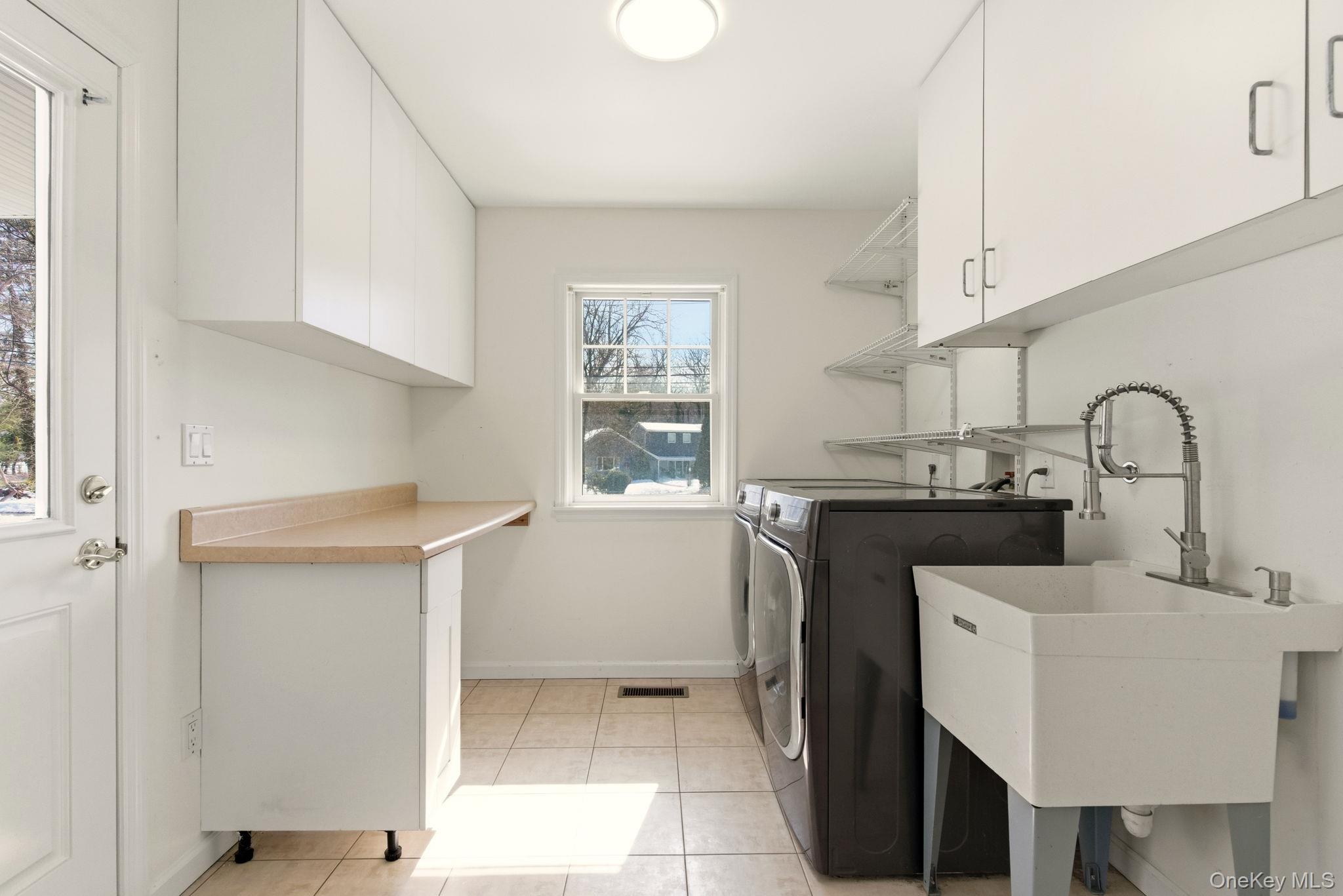 9 Mariners Court Centerport, NY 11721 - Photo 18 of 40 a kitchen with a sink cabinets and window