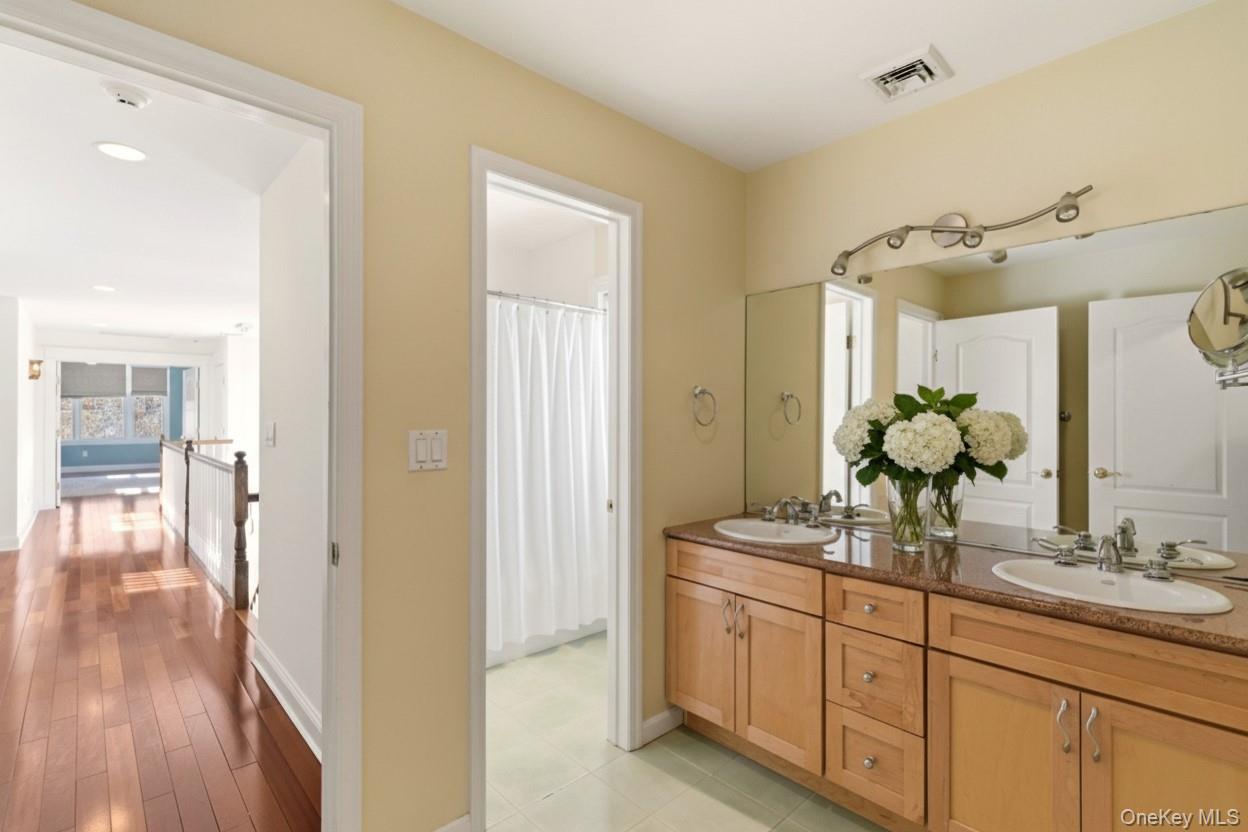 9 Mariners Court Centerport, NY 11721 - Photo 31 of 40 a bathroom with a double vanity sink and a mirror