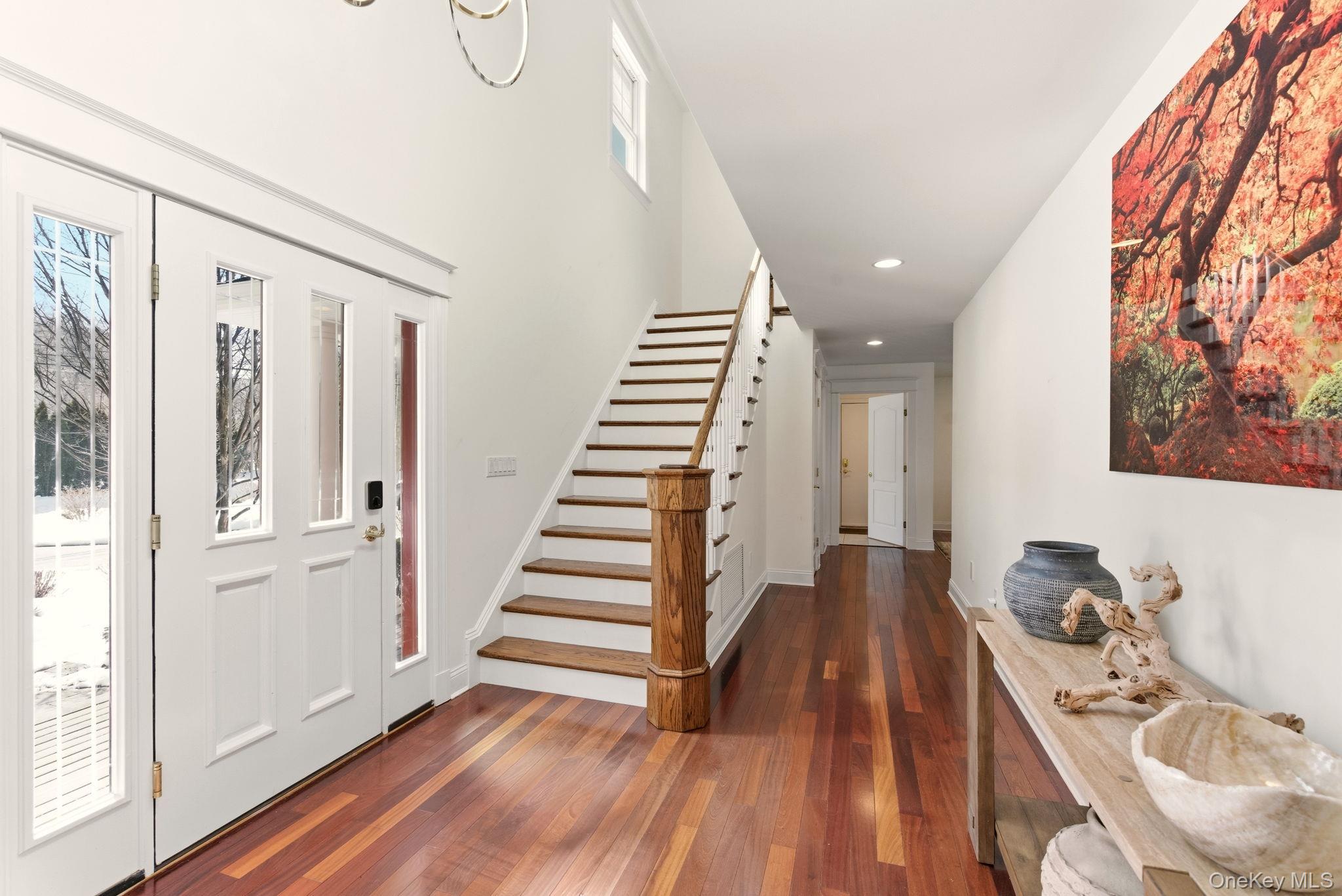 9 Mariners Court Centerport, NY 11721 - Photo 4 of 40 a view of a livingroom with wooden floor and stairs
