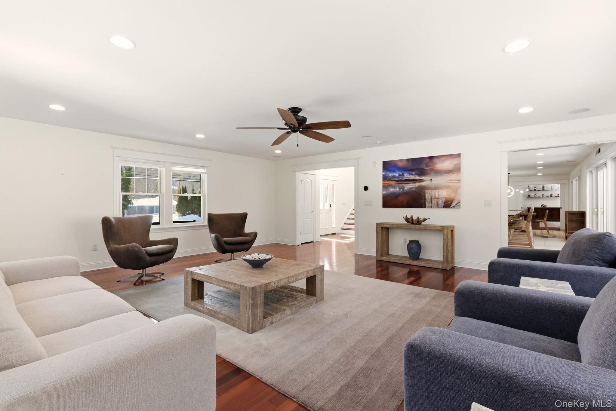 9 Mariners Court Centerport, NY 11721 - Photo 5 of 40 a living room with furniture kitchen view and a fireplace