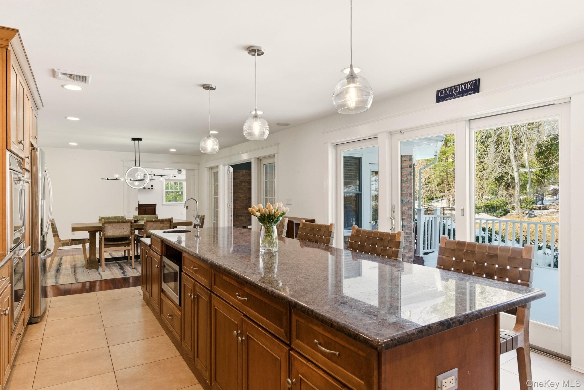 9 Mariners Court Centerport, NY 11721 - Photo 7 of 40 an open kitchen with granite countertop a large island in the center