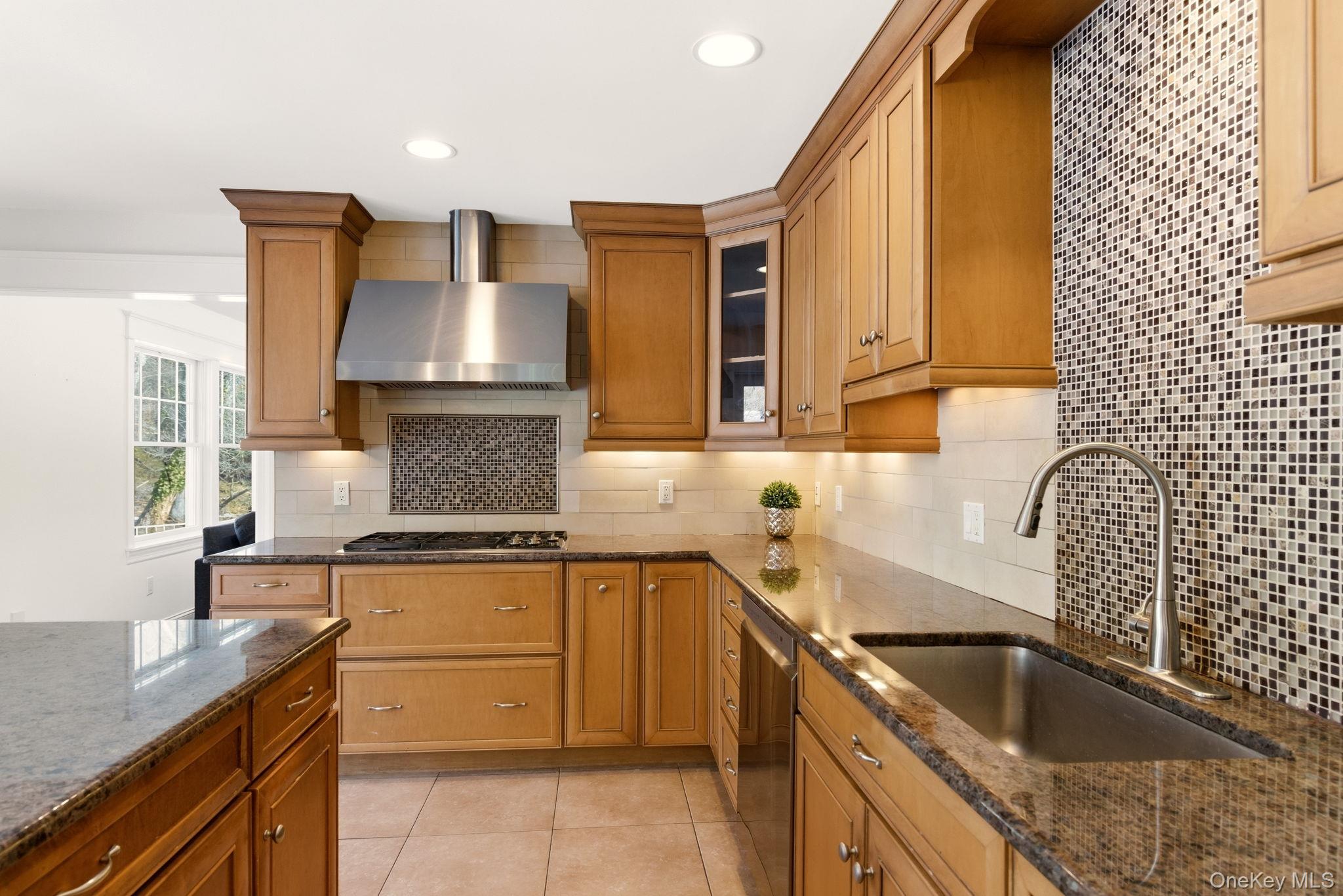 9 Mariners Court Centerport, NY 11721 - Photo 9 of 40 a kitchen with a sink stove and cabinets