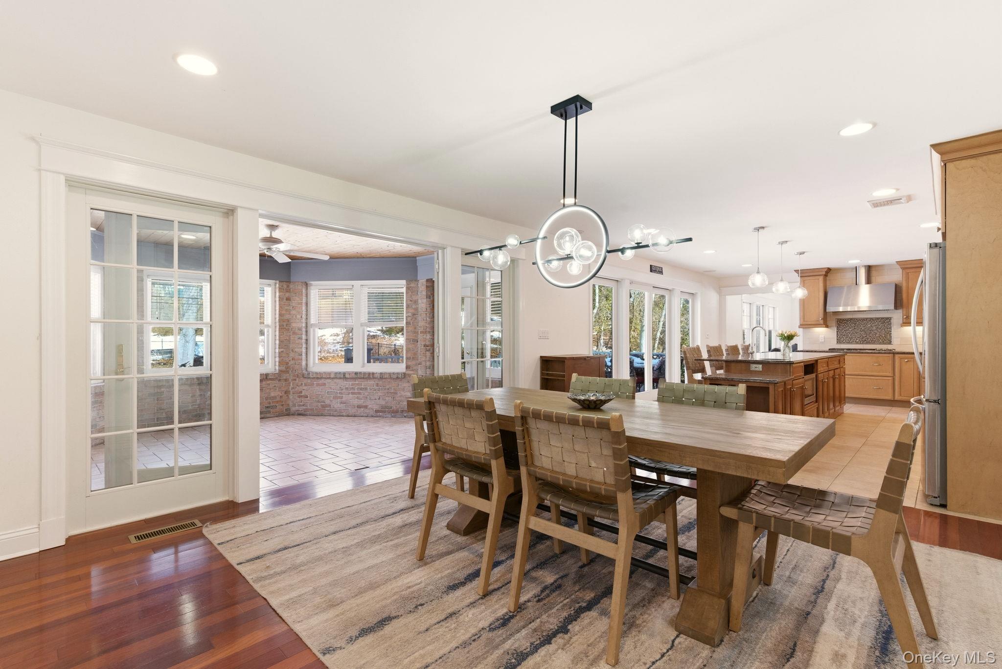 9 Mariners Court Centerport, NY 11721 - Photo 10 of 40 a view of a dining room and livingroom with furniture wooden floor a chandelier