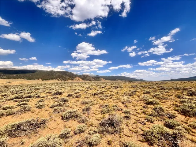 a view of a house with pool and ocean view