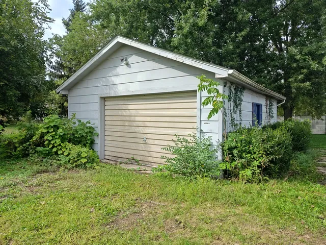 a front view of house with green space