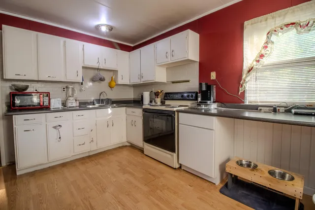 a kitchen with a sink stove and cabinets