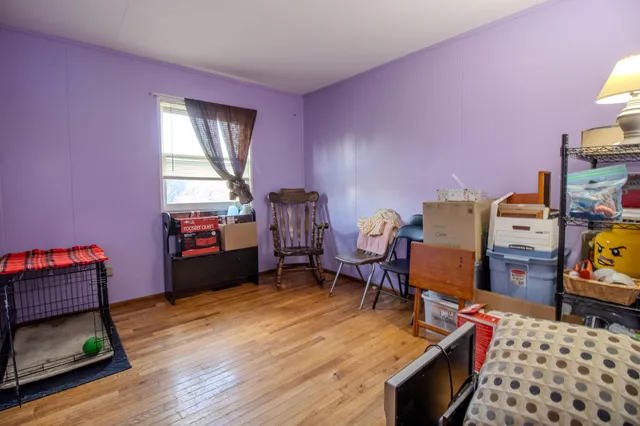 a living room with furniture a rug and a lamp