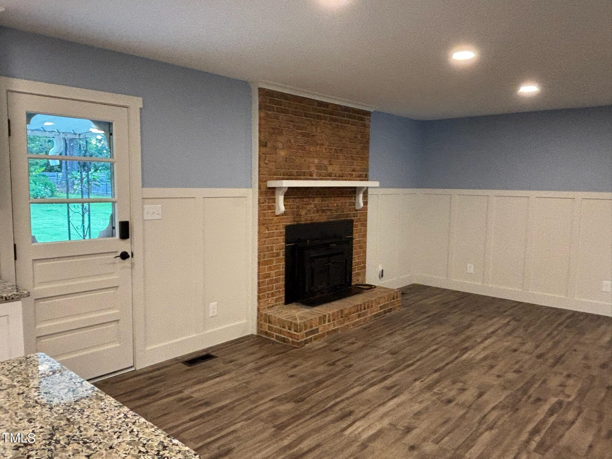 2413 Trawick Road Raleigh, NC 27604 - Photo 12 of 43 a view of an empty room with wooden floor and a window