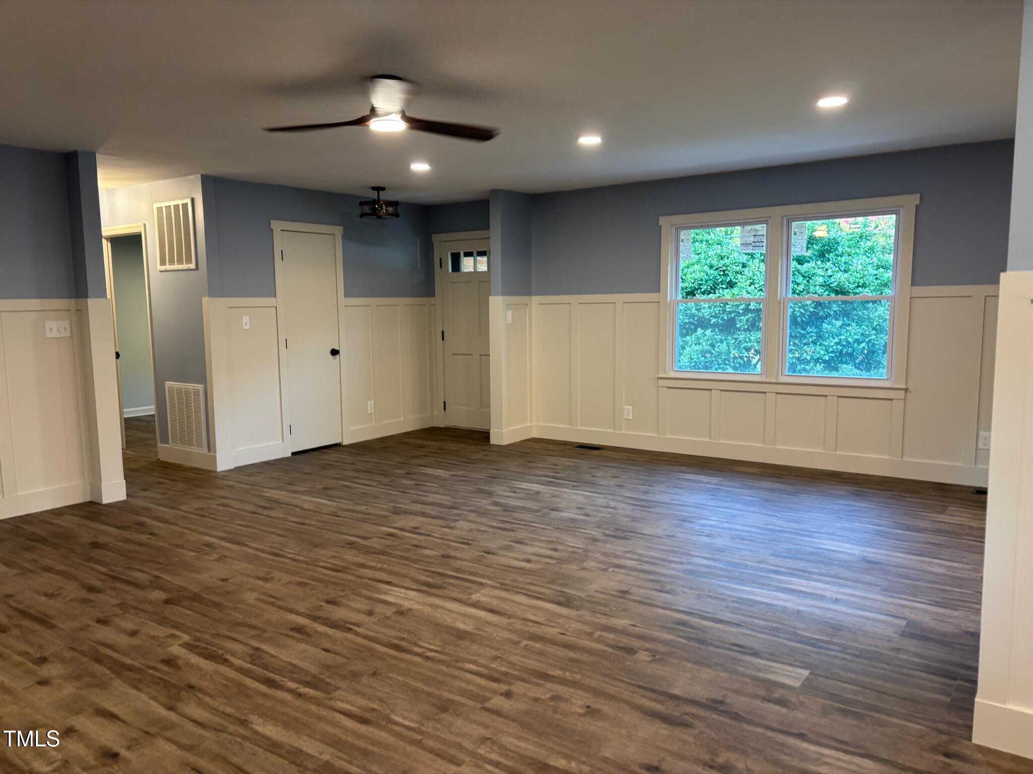 2413 Trawick Road Raleigh, NC 27604 - Photo 13 of 43 an empty room with wooden floor and windows