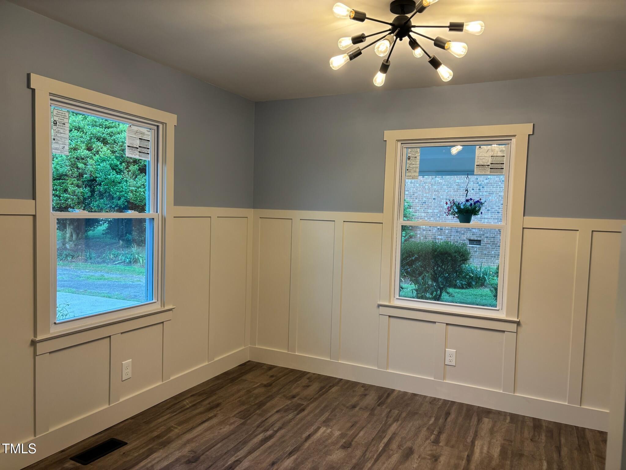 2413 Trawick Road Raleigh, NC 27604 - Photo 9 of 43 wooden floor in an empty room with a window